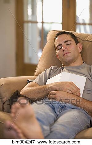 Hispanic man holding book and sleeping in armchair View Large Photo Image Stock Photo - Hispanic man holding book and sleeping in armchair. Fotosearch
