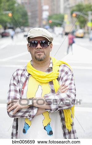 Hispanic man in unique clothing on urban street View Large Photo Image Stock Photo - Hispanic man in unique clothing on urban street. Fotosearch