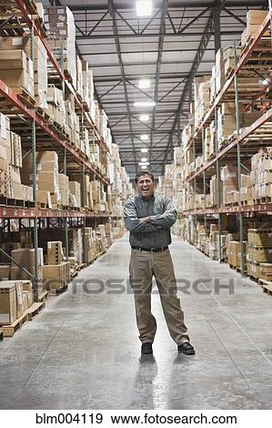 Hispanic man laughing in warehouse View Large Photo Image Stock Photo - Hispanic man laughing in warehouse. Fotosearch
