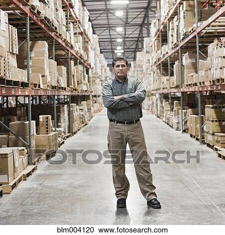 Hispanic man looking serious in warehouse View Large Photo Image Stock Image - Hispanic man looking serious in warehouse. Fotosearch