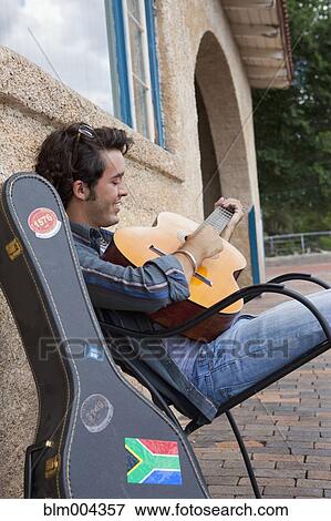 Hispanic man playing guitar View Large Photo Image Stock Photo - Hispanic man playing guitar. Fotosearch