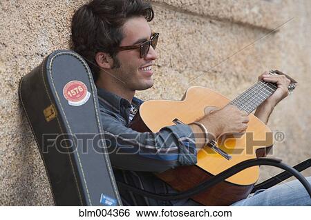Hispanic man playing guitar View Large Photo Image Stock Photograph - Hispanic man playing guitar. Fotosearch