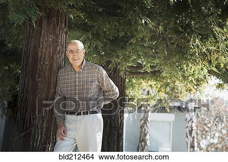 Hispanic man smiling outdoors View Large Photo Image Picture - Hispanic man smiling outdoors. Fotosearch