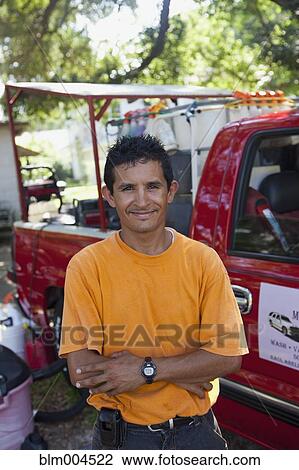 Hispanic man standing near truck View Large Photo Image Stock Image - Hispanic man standing near truck. Fotosearch
