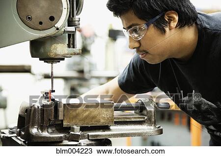 Hispanic man using machinery in machine shop View Large Photo Image Stock Image - Hispanic man using machinery in machine shop. Fotosearch