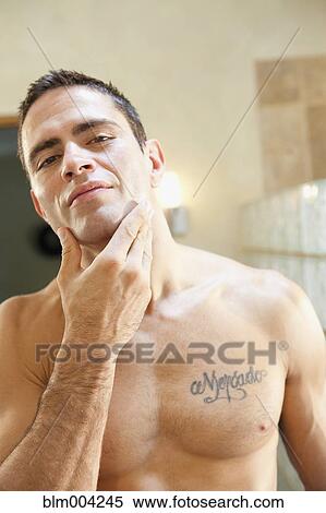 Hispanic man with tattoo on chest View Large Photo Image Stock Photography - Hispanic man with tattoo on chest. Fotosearch