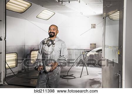 Stock Photo - Hispanic mechanic working in auto shop. Fotosearch