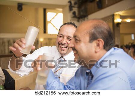 Hispanic men drinking at wedding reception View Large Photo Image Stock Photograph - Hispanic men drinking at wedding reception. Fotosearch