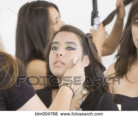 Stock Photo - Hispanic model having makeup applied. Fotosearch
