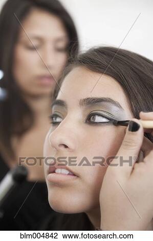 Stock Image - Hispanic model preparing for fashion show. Fotosearch