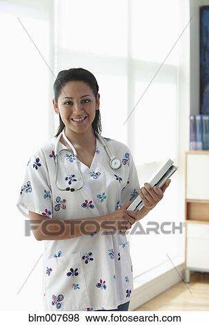 Hispanic nurse in doctor's office View Large Photo Image Stock Photo - Hispanic nurse in doctor's office. Fotosearch