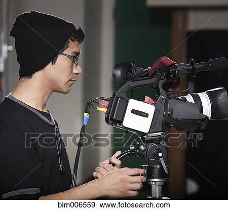 Stock Photo - Hispanic student operating video camera. Fotosearch
