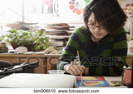 Hispanic student painting in art class View Large Photo Image Stock Image - Hispanic student painting in art class. Fotosearch