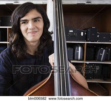 Hispanic student practicing on cello View Large Photo Image Stock Image - Hispanic student practicing on cello. Fotosearch