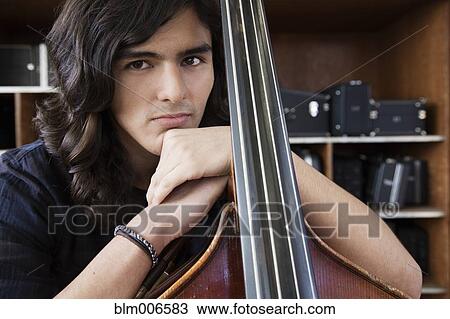 Hispanic student practicing on cello View Large Photo Image Stock Image - Hispanic student practicing on cello. Fotosearch