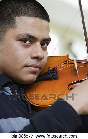 Hispanic student practicing on violin View Large Photo Image Stock Photo - Hispanic student practicing on violin. Fotosearch