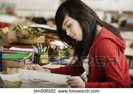 Stock Image - Hispanic student studying in classroom. Fotosearch