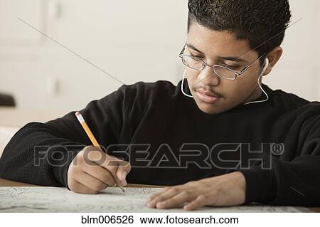 Hispanic student writing in classroom View Large Photo Image Stock Photograph - Hispanic student writing in classroom. Fotosearch
