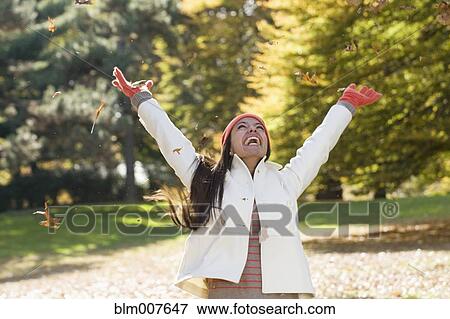 Stock Photo - Hispanic woman cheering in park. Fotosearch