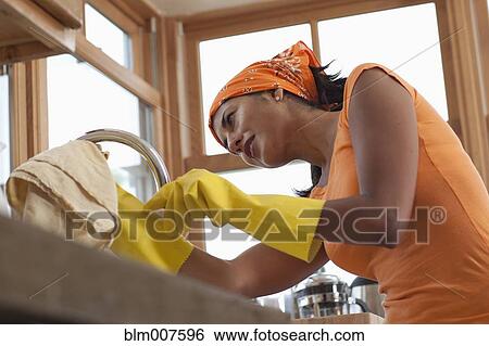 Hispanic woman cleaning kitchen View Large Photo Image Stock Photograph - Hispanic woman cleaning kitchen. Fotosearch