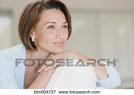 Stock Photo - Hispanic woman daydreaming. Fotosearch