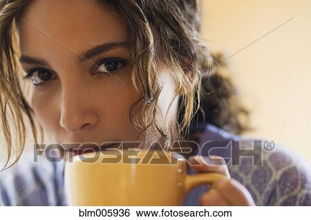 Stock Photograph - Hispanic woman drinking coffee. Fotosearch