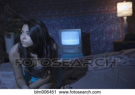 Stock Image - Hispanic woman having trouble sleeping. Fotosearch