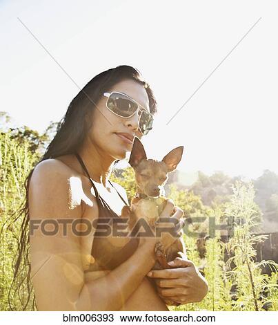 Hispanic woman in bikini holding dog View Large Photo Image Stock Image - Hispanic woman in bikini holding dog. Fotosearch