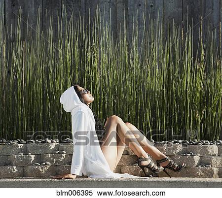 Hispanic woman in high heels sunbathing View Large Photo Image Stock Photography - Hispanic woman in high heels sunbathing. Fotosearch