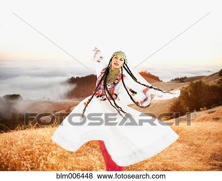 Stock Photo - Hispanic woman in ornate headdress and costume in remote area. Fotosearch