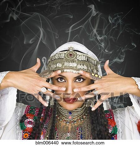 Stock Image - Hispanic woman in ornate headdress. Fotosearch