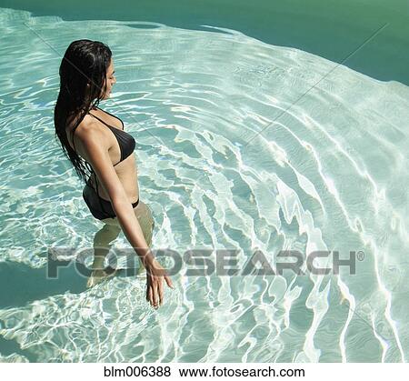 Stock Photo - Hispanic woman in swimming pool. Fotosearch