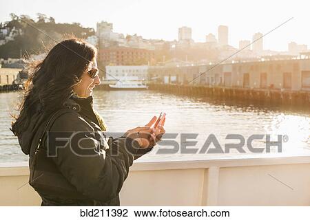 Stock Image - Hispanic woman on boardwalk, San Francisco, California, United States. Fotosearch