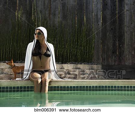Hispanic woman sitting next to swimming pool View Large Photo Image Stock Image - Hispanic woman sitting next to swimming pool. Fotosearch