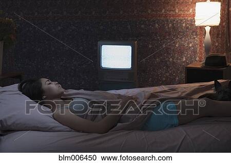 Hispanic woman sleeping with television on View Large Photo Image Stock Image - Hispanic woman sleeping with television on. Fotosearch