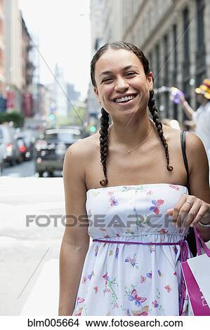Hispanic woman smiling on urban street View Large Photo Image Picture - Hispanic woman smiling on urban street. Fotosearch