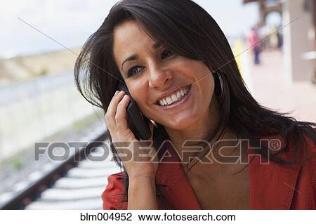 Hispanic woman talking on cell phone View Large Photo Image Stock Image - Hispanic woman talking on cell phone. Fotosearch