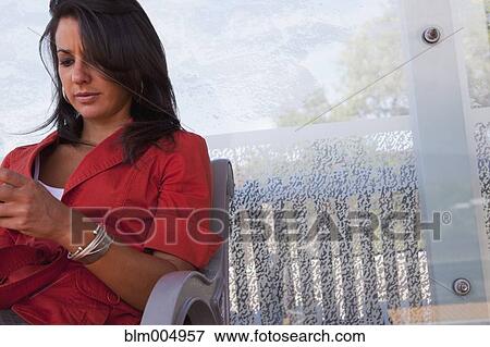 Hispanic woman waiting at bus stop View Large Photo Image Stock Photo - Hispanic woman waiting at bus stop. Fotosearch