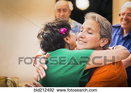 Hispanic women hugging in restaurant View Large Photo Image Stock Image - Hispanic women hugging in restaurant. Fotosearch