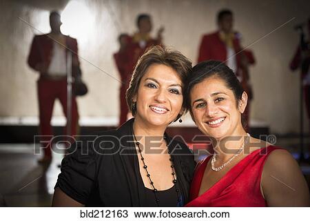 Hispanic women smiling at wedding reception View Large Photo Image Stock Image - Hispanic women smiling at wedding reception. Fotosearch