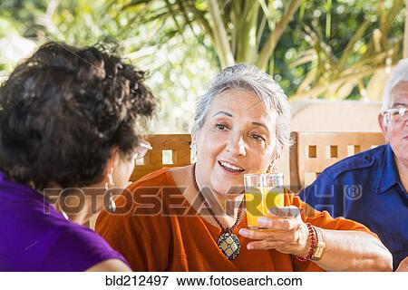 Hispanic women talking at table View Large Photo Image Stock Photo - Hispanic women talking at table. Fotosearch