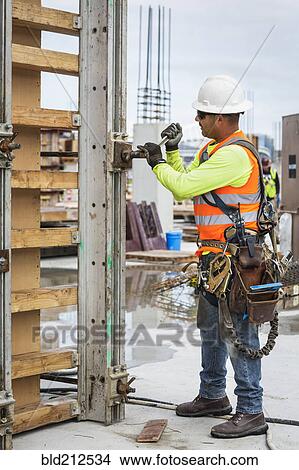 Picture - Hispanic worker at construction site. Fotosearch
