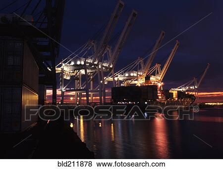 Stock Photo - Illuminated cranes over commercial dock at night, Long Beach, California, United States. Fotosearch