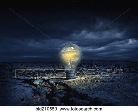 Illuminated light bulb in cracked earth View Large Photo Image Stock Photo - Illuminated light bulb in cracked earth. Fotosearch