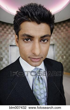 Indian businessman in office lobby View Large Photo Image Stock Image - Indian businessman in office lobby. Fotosearch