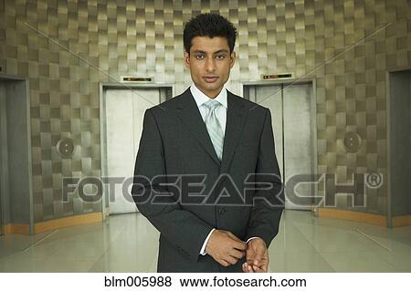 Stock Photo - Indian businessman in office lobby. Fotosearch