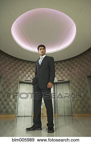 Stock Photo - Indian businessman in office lobby. Fotosearch