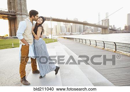 Indian couple kissing by bridge, New York, New York, United States View Large Photo Image Stock Image - Indian couple kissing by bridge, New York, New York, United States. Fotosearch