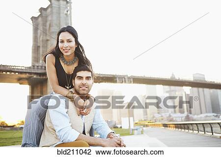 Indian couple smiling by bridge, New York, New York, United States View Large Photo Image Stock Image - Indian couple smiling by bridge, New York, New York, United States. Fotosearch