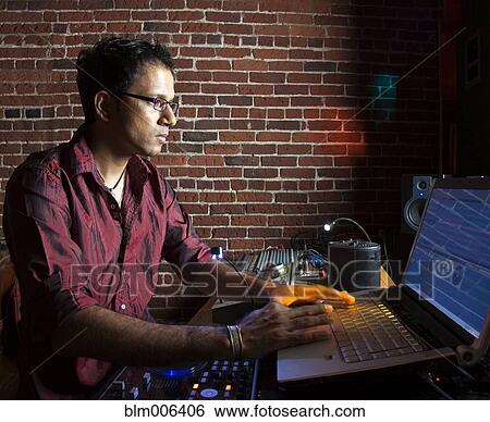 Indian man typing on laptop View Large Photo Image Stock Photograph - Indian man typing on laptop. Fotosearch